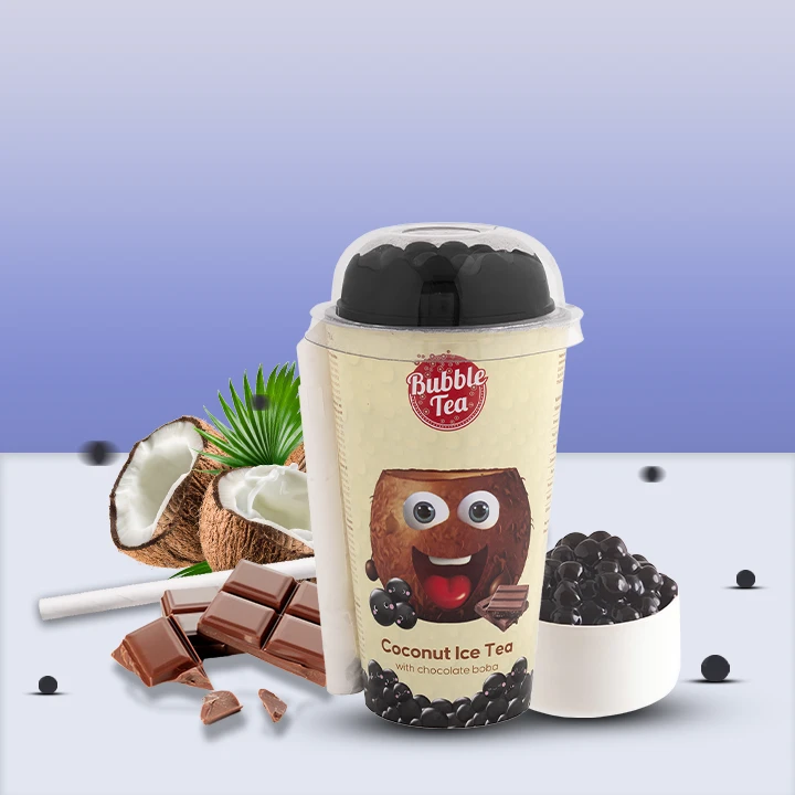 Coconut Ice Tea bubble tea cup with chocolate boba, surrounded by coconuts, chocolate pieces, and a bowl of tapioca pearls.