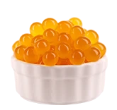 A small white bowl filled with bright orange popping boba pearls.
